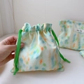 Detail of colorful tie-dye drawstring storage bag with mint green cord and woven label - Small Drawstring Bag
