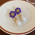 Detail of purple enamel flower earrings with white pearl drops on a white plate - Purple Enamel Flower Pearl Drop (Silver Earring Post)