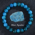 Detailed view of raw blue apatite stone surrounded by polished crystal beaded bracelet - Apatite