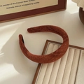 Minimalist wide brown wool sponge headband with matte texture on jewelry display - Red