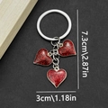 Detail showing red glitter heart keychains with dimensions 7.3cm length and 3cm width - Enamel Red Heart Style (ER411)