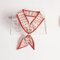 Red and white vintage floral print silk scarf tied in a bow on a white mesh tray - Red White Retro