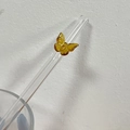 Heat-resistant glass straw featuring a yellow butterfly ornament in a glass cup - Gold