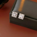 Macro shot of silver square stud earrings with central zircon and pavé setting halo - Silver Style / Silver