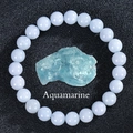 Detail of round light blue aquamarine beads with high gloss on a black texture - Aquamarine