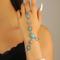 Detail of vintage silver hand chain featuring turquoise stones and ethnic sun patterns - Retro Turquoise Sun Flower Hand Chain Bracelet (5925) / Antique Silver
