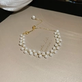 Macro detail of gold plated pearl bracelet with vintage style and adjustable chain clasp - Pearl Chain Style / Bracelet - Gold