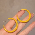 Minimalist yellow geometric hoop earrings with silver needle shown in palm of hand - 45# Silver Earring Post - Bright Yellow - Large