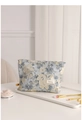 Detail of light blue floral jacquard makeup bag with gold zipper and HR label - Large / Jacquard Tile Blue
