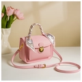 Pink handbag with decorative silk scarf and gold hardware near fresh tulips - Pink
