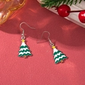 Detail of Christmas tree earrings with green enamel and yellow stars on red festive background - D1299 (Snow Tower Xmas Tree)