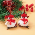 Pair of plush Christmas snowman hair clips with red hats and stars on a festive background - Christmas Clip Style 12
