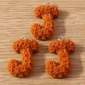 Macro shot of 3 caramel resin J-letter charms with micro rose embossing and metal rings - Letter J / 10 Pieces Pack / Caramel color