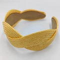 Detailed view of yellow raffia braid texture on a handmade wide fashion headband - Yellow