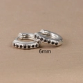 Macro shot of 6mm silver hoop earrings with black zircon stones and polished finish - 6mm Silver Black Rhinestone (E1014-6mm)