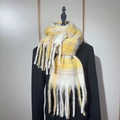 Rainbow plaid scarf in yellow and white featuring soft mohair fringes on a black coat - Yellow Boucle Yarn