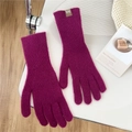 Detail view of deep magenta knitted gloves with ribbed texture and brown woven label - One Size / Rose Purple