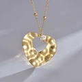 14K gold plated stainless steel necklace with heart pendant and pearl accent on grey background - Gold