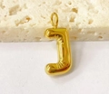Macro shot of 3D puffy gold letter J pendant with high-shine metallic finish on stone - Letter-J / Steel
