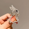 Detailed view of a crystal-encrusted rabbit brooch with golden bow and black gem eye - X0256 Gold Rabbit