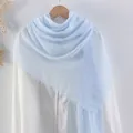 Light blue cotton linen scarf with pleated texture and frayed edges on wooden hanger - Light Blue