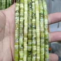 Close-up of natural green jade cylinder beads showing detailed stone texture and veins - Light Green Jade