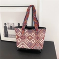 Ethnic canvas tote bag featuring geometric patterns and colorful woven handles - Red