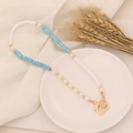Detail of bohemian polymer clay necklace with white and blue beads, pearls and heart clasp - Camo Blue