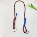Oranje en blauw gevlochten koord met zilveren metalen ringen op een witte achtergrond - Universele Riem / Blauw Oranje Streep