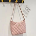 Pink quilted bucket bag with golden flower emblem and slender leather strap for women - Pink