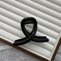 Thick black hair claw clip with twisted glossy finish on a minimalist jewelry tray - 8cm Round Top / Bright Black