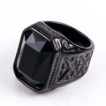 Detail of a matte black stainless steel ring featuring a large rectangular faceted gemstone - US 7 / Black Base Black Gemstone