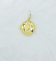 Detail of a golden round locket pendant with a Virgin Mary relief and small diamonds - Round Virgin Mary