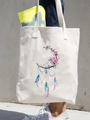 Cream canvas tote bag featuring dreamcatcher and pink flower print held by a model - Crescent Moon Dreamcatcher