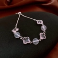 Detailed shot of silver flower bracelet with lilac clover charms and pink beads - Silver - Pink Bead Purple Clover