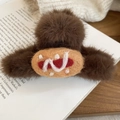 Detail view of a brown plush bread-shaped hair claw clip on a white vintage book - Hotdog Style (Coffee Red Large)