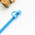 Close-up of a blue reusable silicone dust cap and straw cover on a white background - Light Blue