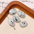Macro shot of oval natural stone beads with grey speckles on sand in a wooden tray - Grey Black Spotted Texture Oval Style (15号)