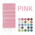 Close-up of pink striped Turkish beach towel with tassels and multiple color options - Pink