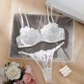 Detailed view of white lace lingerie set with floral embroidery and mesh texture - S / White