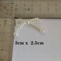 Detailed view of a white pearl bow accessory measuring 3cm x 2.5cm for DIY crafts - 36-Pearl Bow