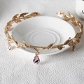Detail of golden leaf bridal crown with rhinestones and pink crystal teardrop pendant - Gold with Pink Gemstone