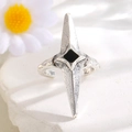 Detail of gothic silver star ring with black diamond center on stone backdrop - Four-Pointed Star (10107) / Antique Silver