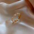 Gold plated open ring with hollow heart patterns and clear zircon stones on beige silk - Heart Zirconia