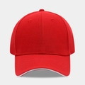 Front view detail of a classic red baseball cap with white sandwich visor and cotton texture - Adjustable / Red