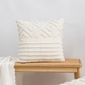 Modern creamy white bouclé embroidered cushion cover on a wooden bench with textured throw - Chenille Qingyun Pattern