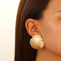 Close-up of golden seashell stud earring with radial texture on a female model - Gold Shell Stud Earrings (K-066)