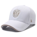 White baseball cap with shield embroidery and contrast khaki trim on the brim - White