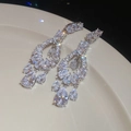 Macro shot of silver drop earrings with sparkling zircons on a ceramic plate - 45# Silver Zirconia Oval Hollow Pendant Studs