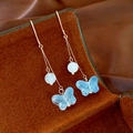 Detail of long tassel butterfly earrings with blue glass charms and white beads - Blue Butterfly Ear Hooks